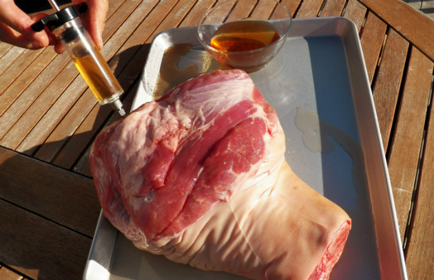 Using a marinade injector on pork