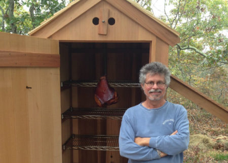 Steven Raichlen in front of smokehouse