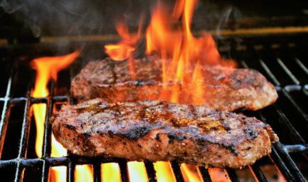 Strip steaks on grill
