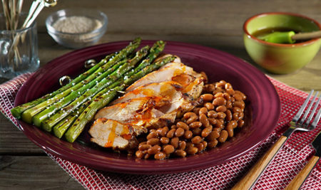 Grilled Chicken Breasts with Spanish Ham, Cheese, and Pimentón Butter and Grilled Asparagus Rafts