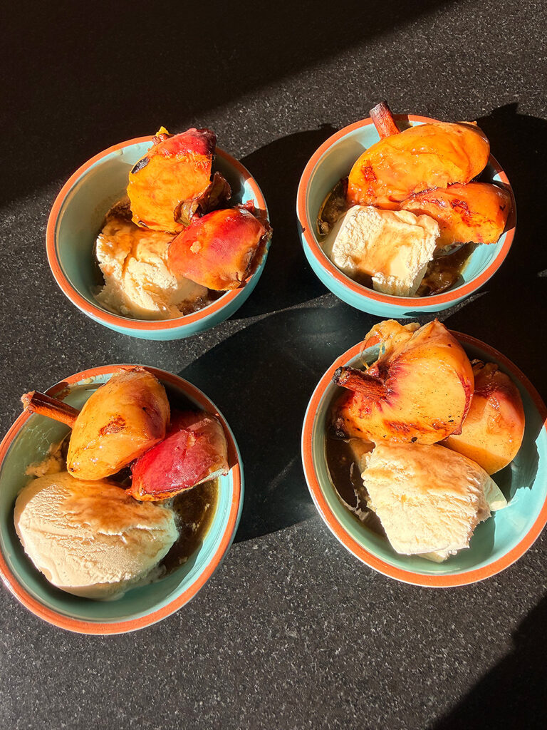 Cinnamon-grilled peaches with bourbon glaze and vanilla ice cream