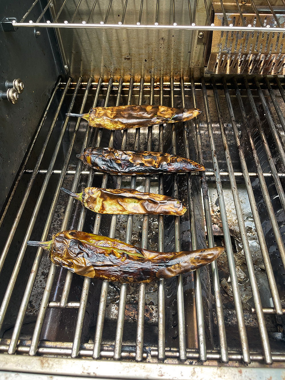 Fire-roasted green chiles blistered on the grill