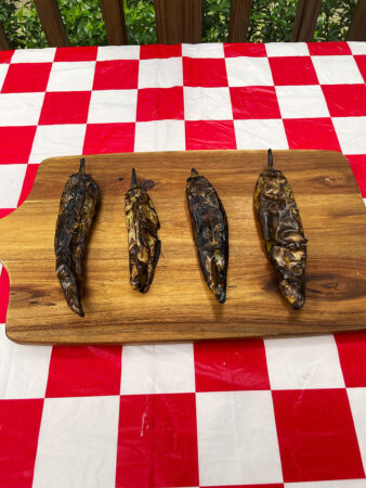 Fire-roasted green chiles blistered on the grill
